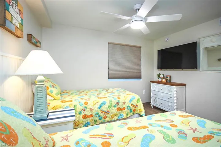 Bedroom with ceiling fan and wood finished floors