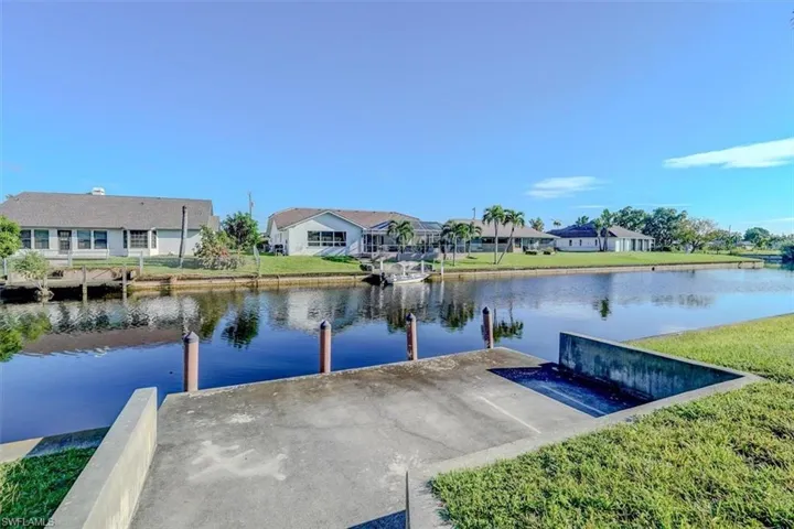View of dock featuring a water view and a yard