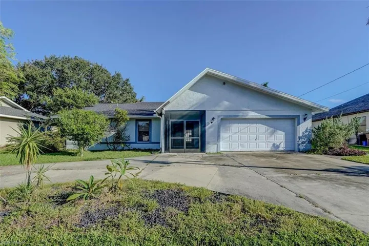 Ranch-style home with a garage and circular driveway