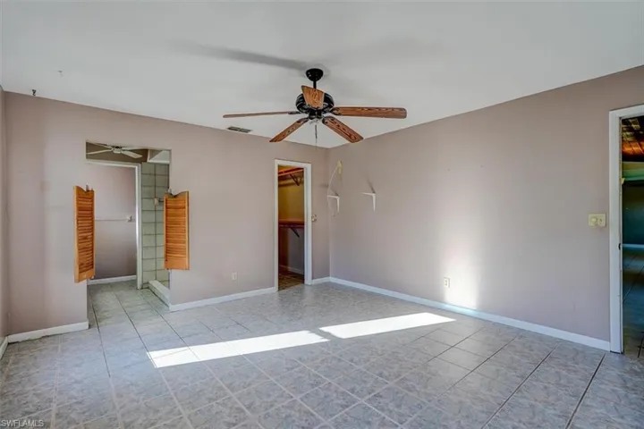 Unfurnished room featuring ceiling fan and light tile patterned flooring
