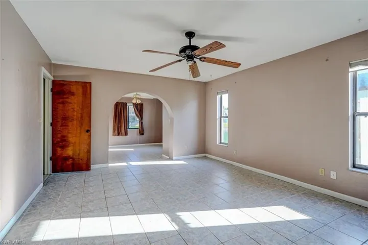 Spare room featuring a wealth of natural light and ceiling fan