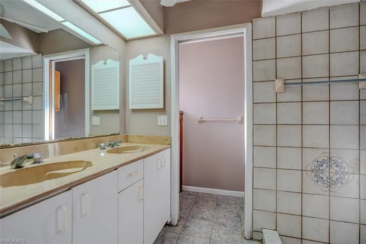 Bathroom featuring tile patterned flooring and vanity