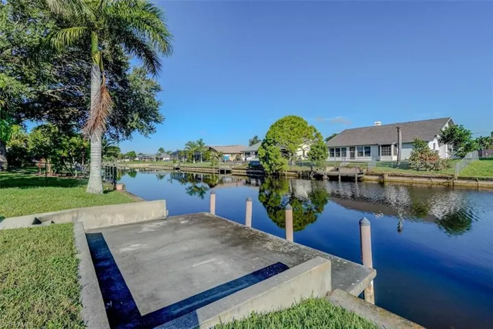 View of dock featuring a water view and a yard
