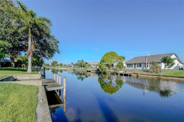 View of dock featuring a water view and a yard