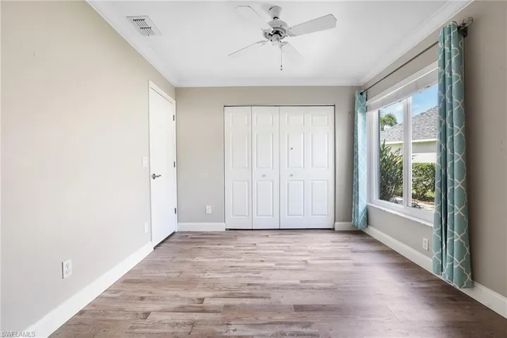 Unfurnished bedroom featuring multiple windows, ceiling fan, and light hardwood / wood-style floors