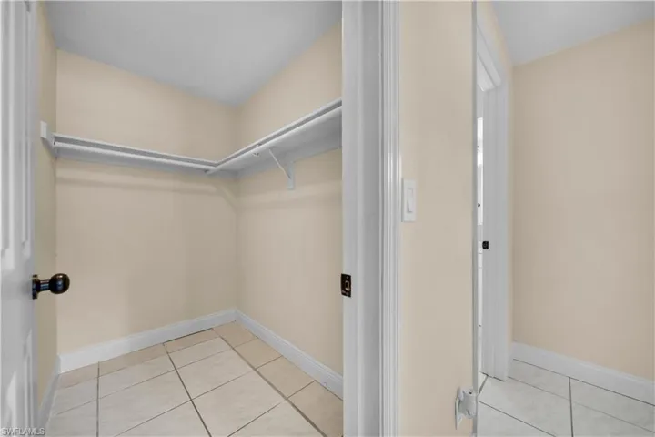 Walk in closet with tile patterned floors
