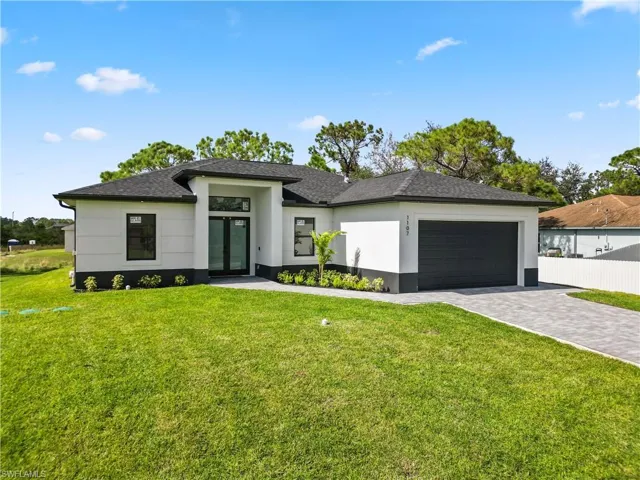 Prairie-style home with a front lawn and a garage