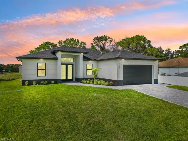 Prairie-style house featuring a garage and a yard