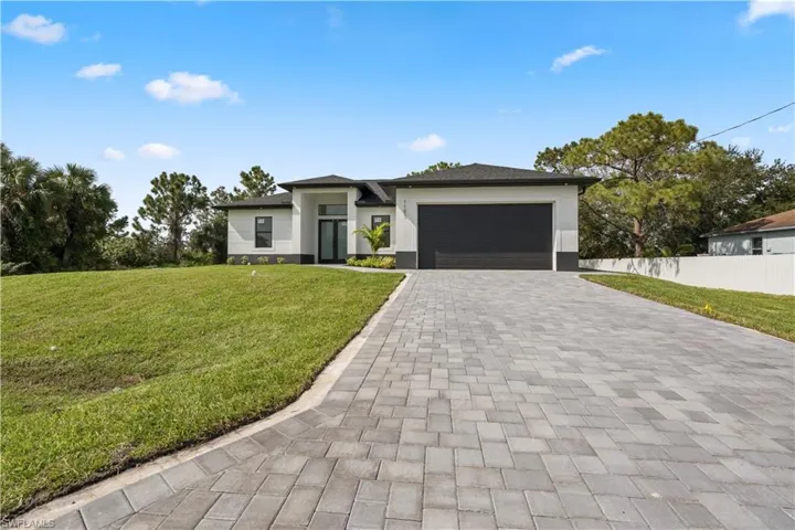 Prairie-style home with a front lawn and a garage