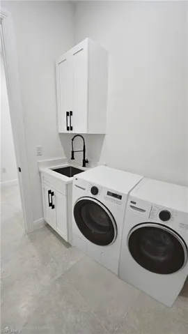 Washroom with independent washer and dryer and cabinet space