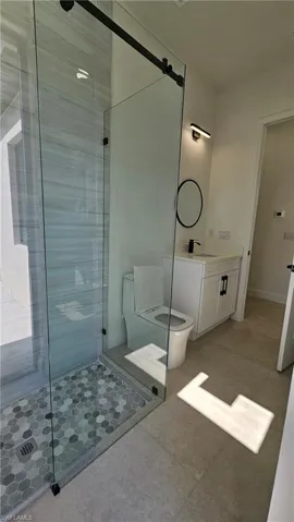 Bathroom with a stall shower and vanity