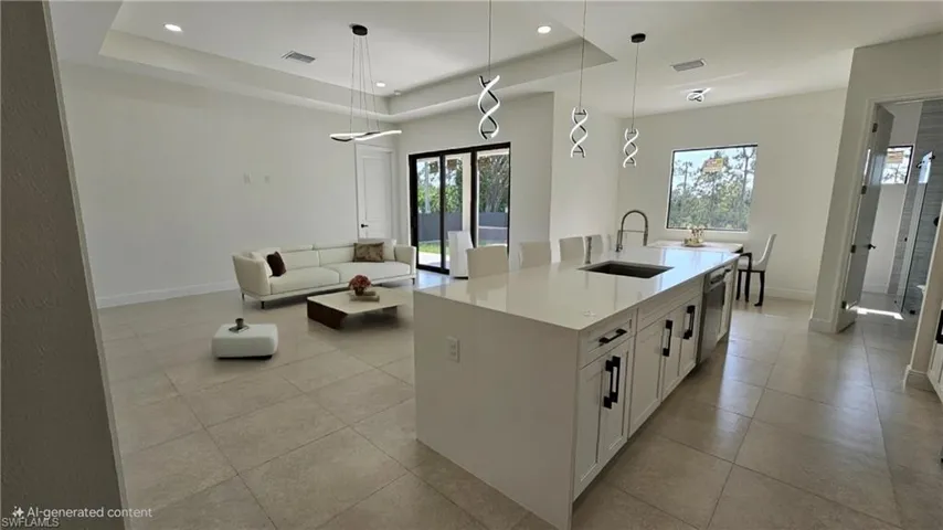 Kitchen featuring a raised ceiling, white cabinets, pendant lighting, light countertops, and recessed lighting