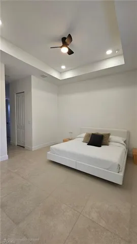Bedroom featuring recessed lighting, a raised ceiling, and ceiling fan