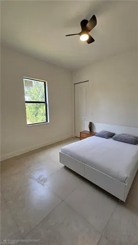 Bedroom featuring ceiling fan and a closet