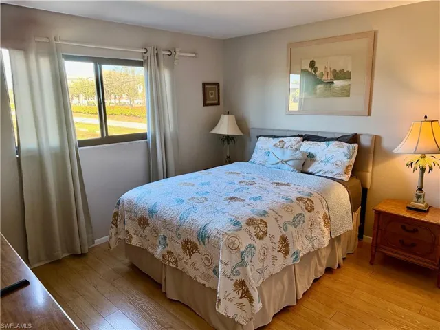 Bedroom with light wood-type flooring and baseboards
