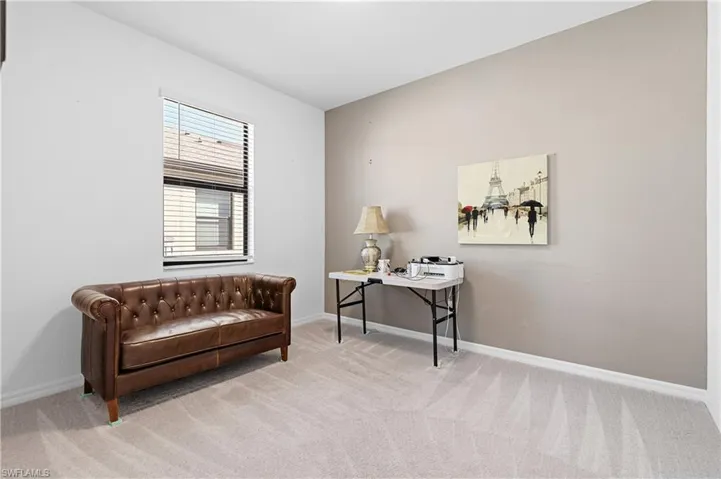 Bedroom 3 with light carpet and a desk