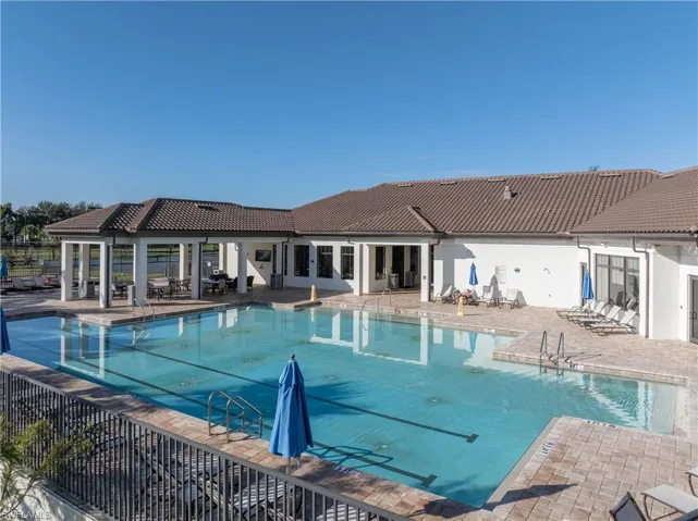 Resort Style pool including lap pool and a patio area