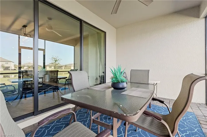 Screened Lanai featuring ceiling fan and outdoor dining space