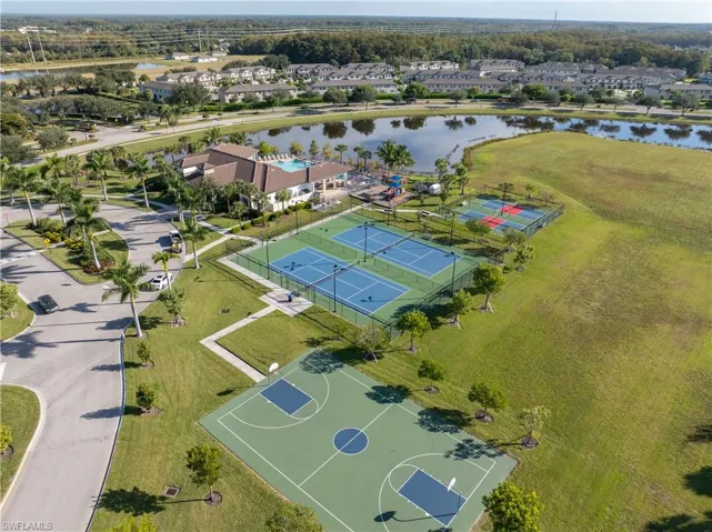 Aerial view of residential area featuring a nearby body of water