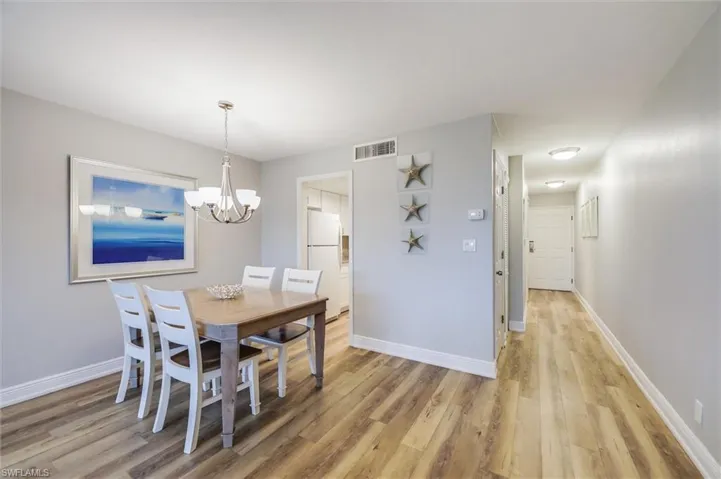 Dining room with a notable chandelier and light hardwood / wood-style floors