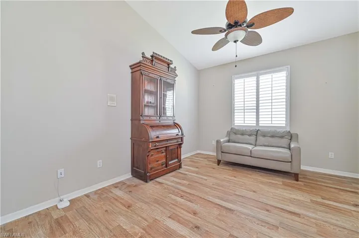 Sitting room with lofted ceiling, light hardwood / wood-style flooring, and ceiling fan
