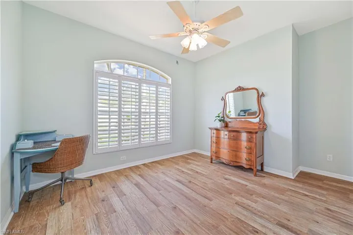 Office space with ceiling fan and light hardwood / wood-style floors