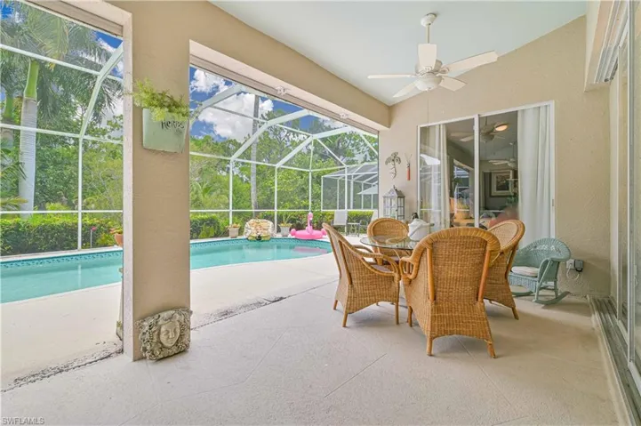 View of swimming pool featuring a patio, a lanai, and ceiling fan