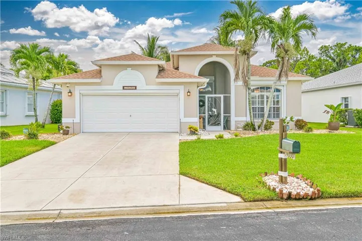 Mediterranean / spanish-style home with a front yard and a garage