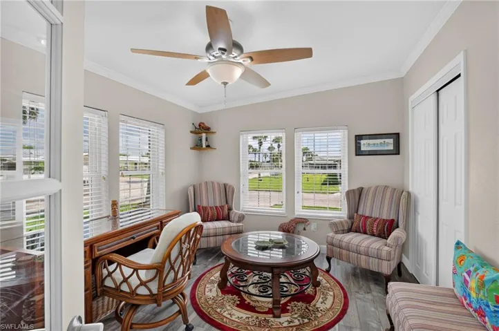Recessed lighting, wood-finish flooring, multiple windows with blinds, ceiling fan with light fixture, and white bi-fold closet doors