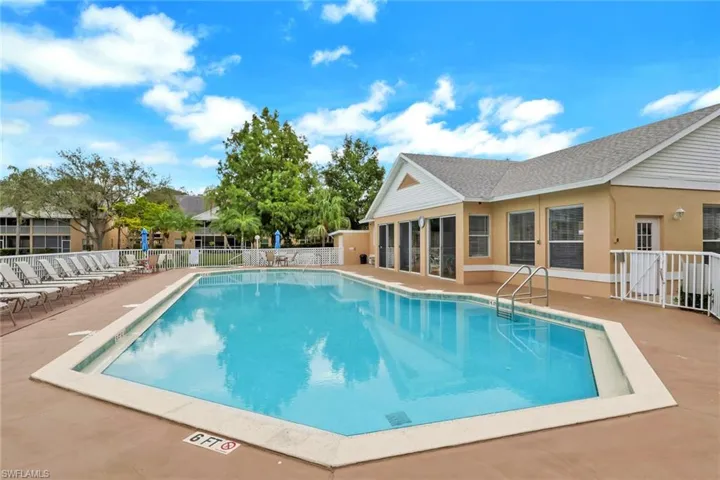Community pool with a patio