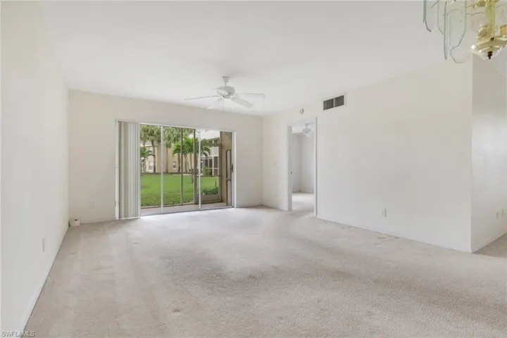 Carpeted empty room with baseboards and ceiling fan