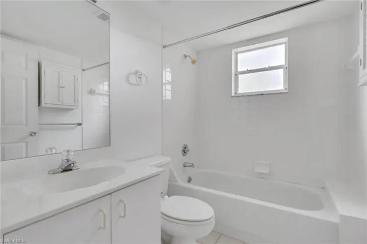 Full bath with vanity, tub / shower combination, and light tile patterned floors