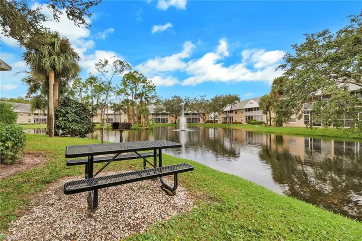 View of property's community with a residential view, a yard, and a water view