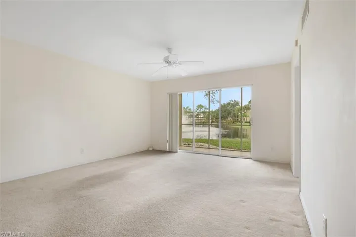 Unfurnished room with light carpet and a ceiling fan