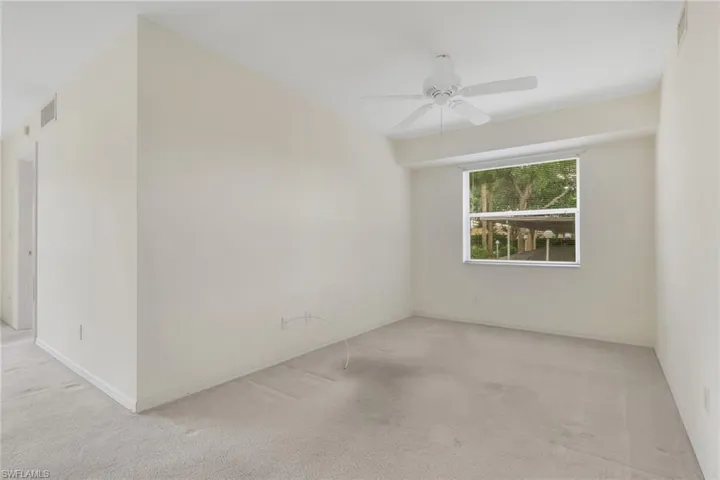 Unfurnished room featuring carpet and ceiling fan