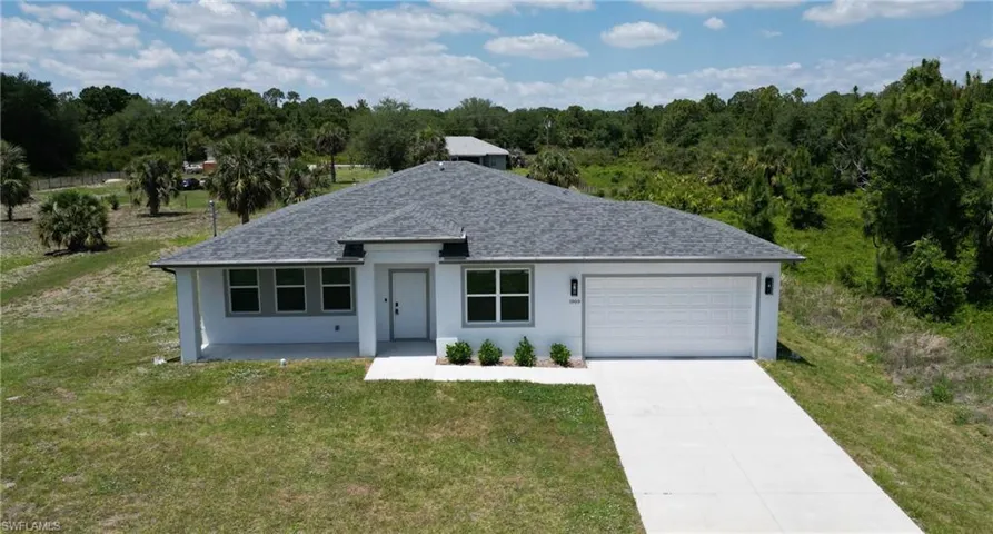 Contemporary single-story residence featuring a gray shingle roof, white exterior siding, and a two-car garage