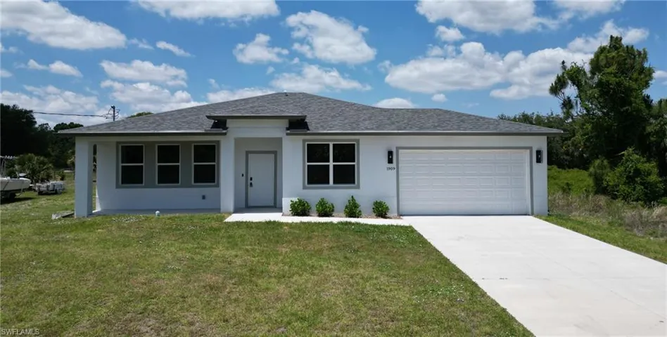 Single-story residence featuring a two-car garage and a paved driveway