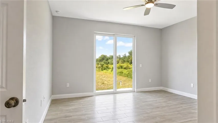 Interior room featuring wood-look tile flooring and light gray wall paint