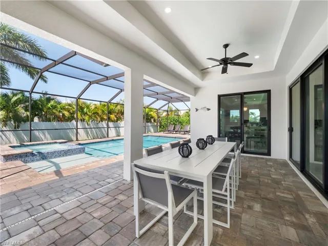 Integrated pool / spa featuring a patio, outdoor dining space, a sunroom, and a lanai