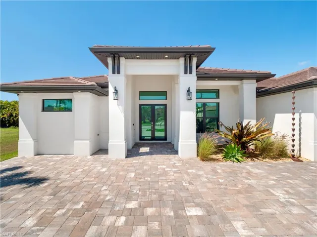 Entrance to property with french doors, stucco siding, and a tile roof