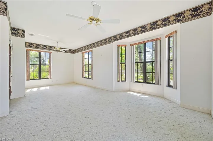 Unfurnished room with baseboards, carpet flooring, visible vents, and a ceiling fan