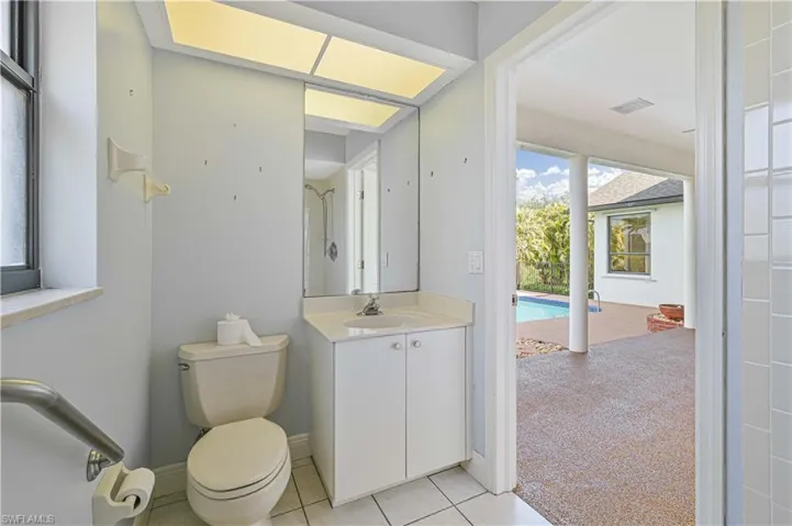 Bathroom with visible vents, toilet, vanity, tile patterned flooring, and baseboards