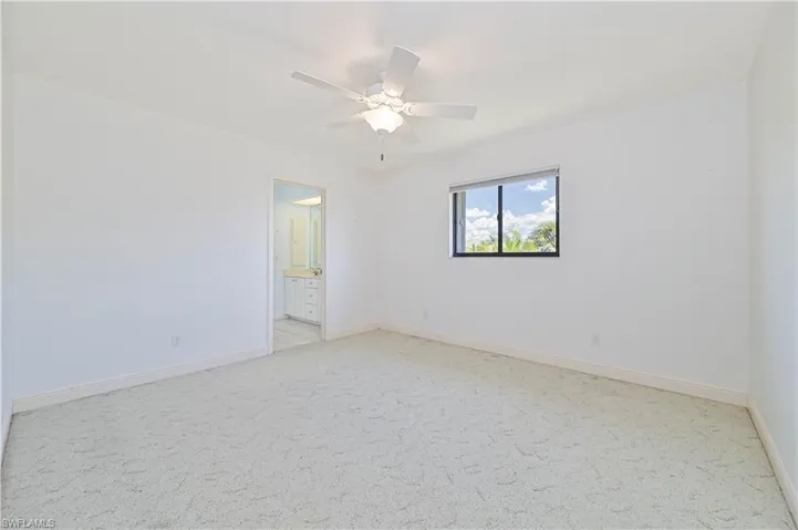 Unfurnished room with light carpet, ceiling fan, and baseboards