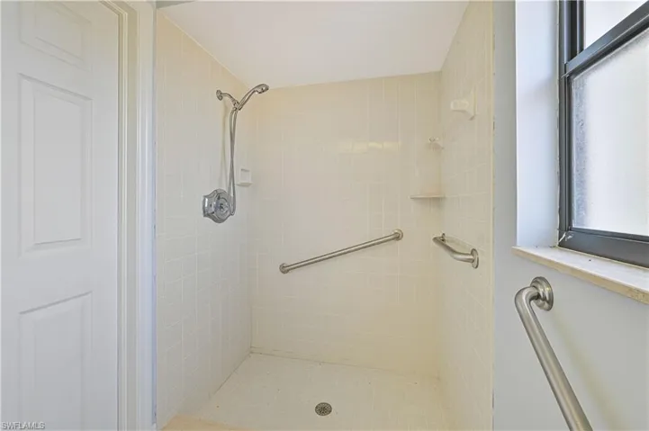 Full bath featuring a shower stall