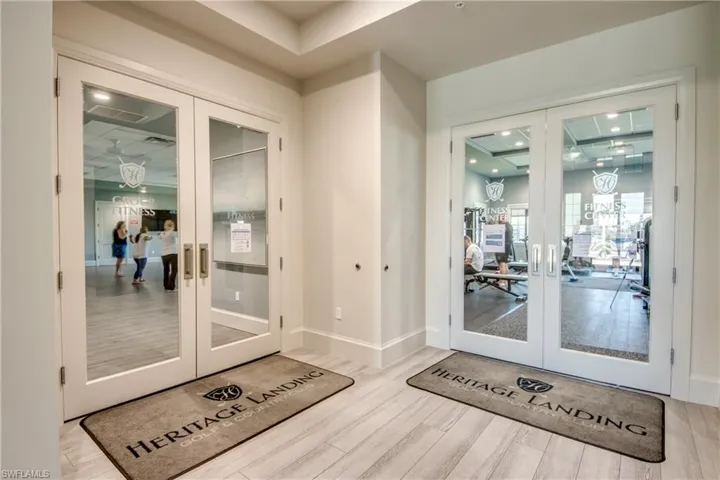 Doorway to outside with french doors, recessed lighting, and wood finished floors