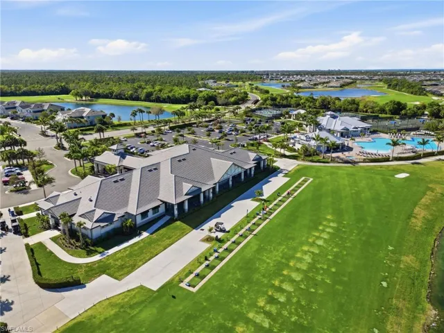 Aerial view of residential area with a large body of water and a golf course