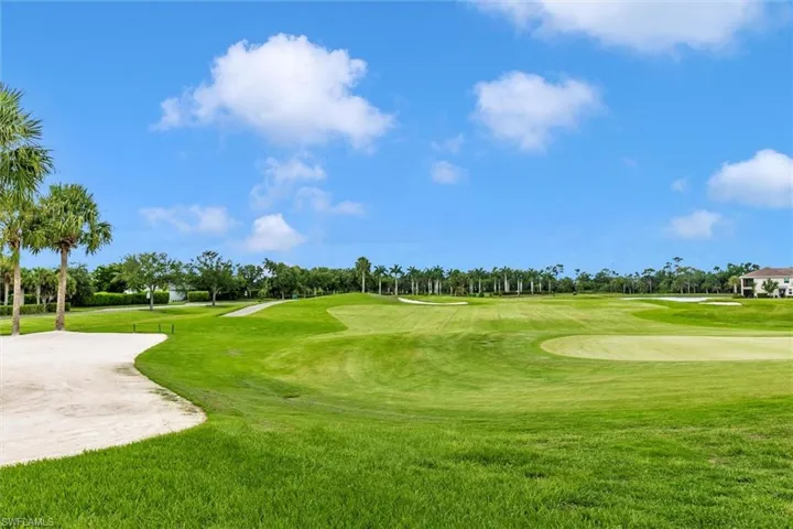 Surrounding community with view of golf course and view of scattered trees
