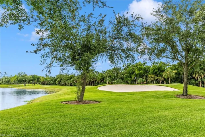 Surrounding community featuring view of wooded area and a water view