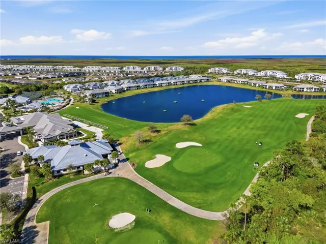 Aerial view of residential area with a large body of water and a golf course