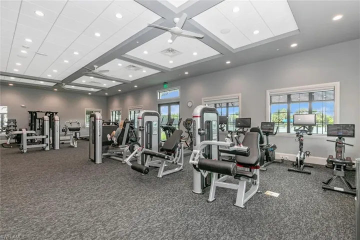 Gym featuring recessed lighting, ceiling fan, and coffered ceiling